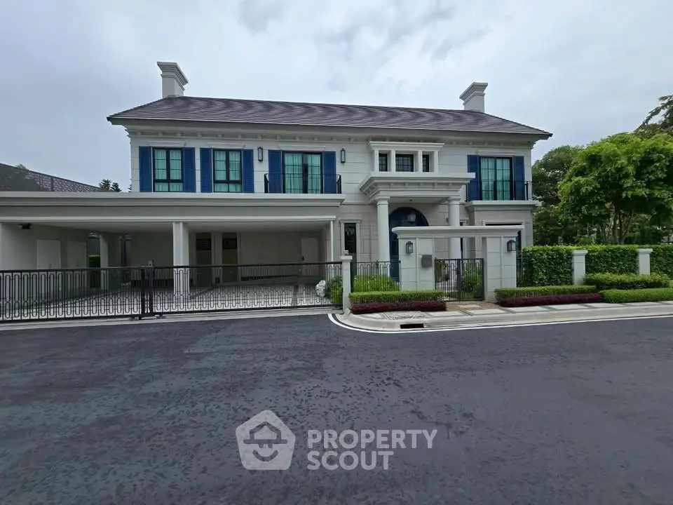 Luxurious two-story mansion with elegant facade and spacious driveway in a serene neighborhood.