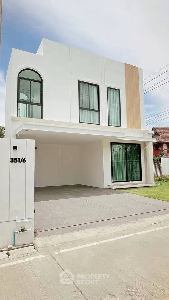 Modern two-story house with sleek design and large windows
