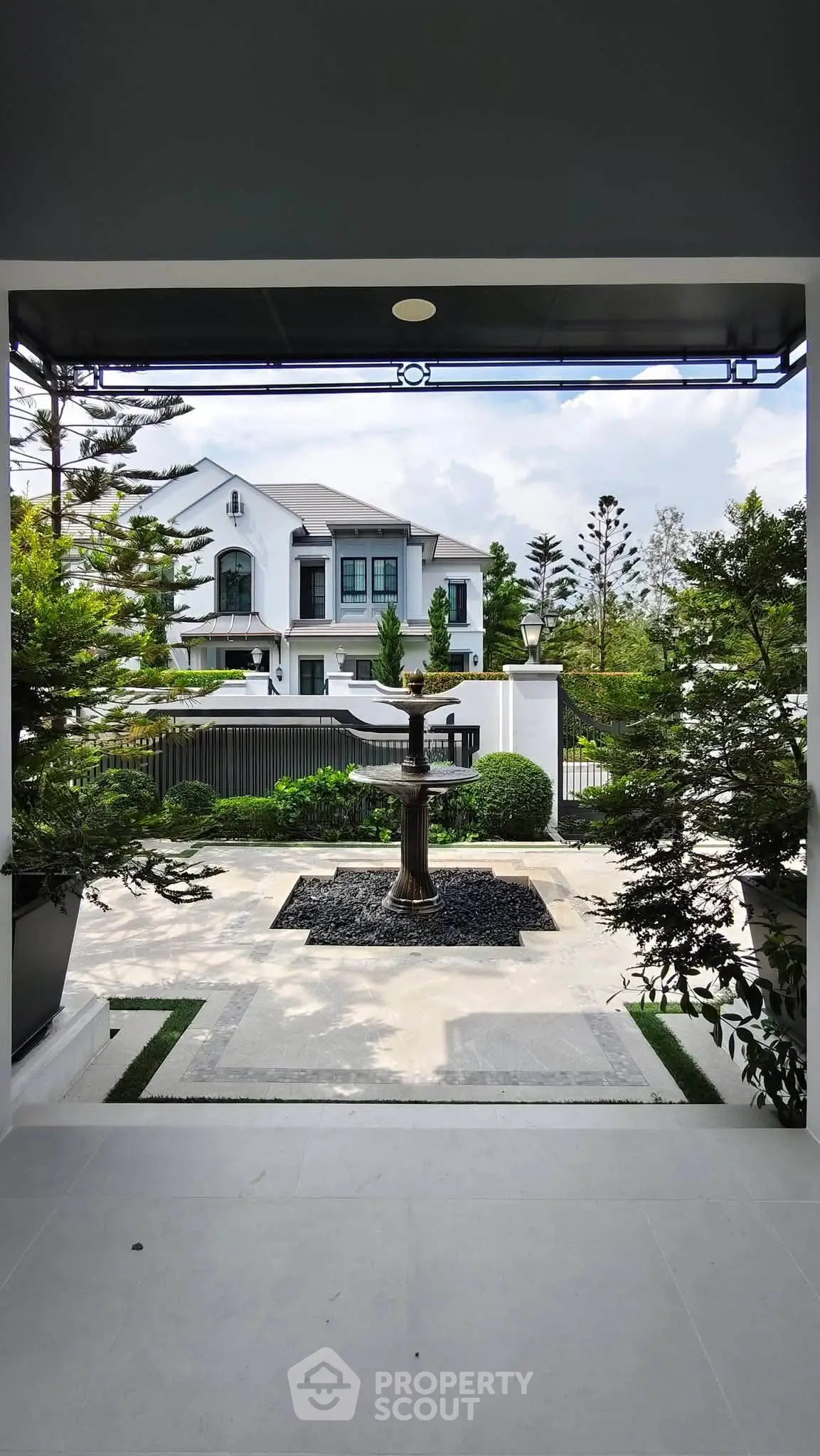 Elegant entrance view of a luxurious modern villa with manicured garden and stylish architecture.