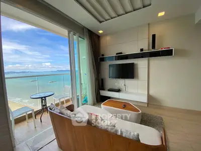 Luxurious living room with stunning ocean view and modern decor, featuring a cozy seating area and balcony access.