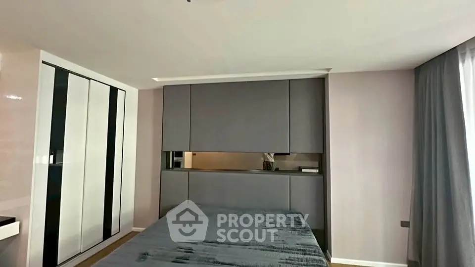 Modern bedroom with sleek built-in storage and stylish decor