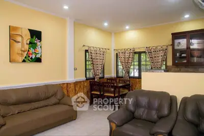 Cozy living room with elegant decor and dining area, perfect for family gatherings.