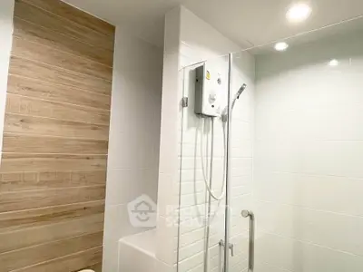 Modern bathroom with sleek shower and wood accent wall, perfect for a contemporary home.