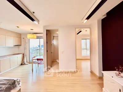 Spacious open-plan apartment with modern kitchen and city views, perfect for urban living.