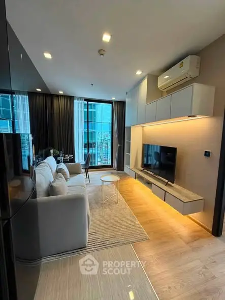 Modern living room with sleek design, large windows, and stylish furniture in a high-rise apartment.