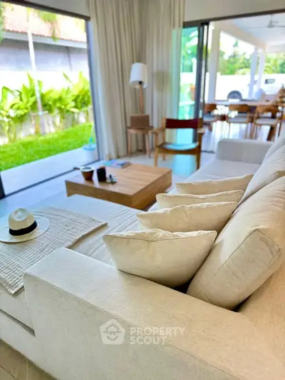Luxurious living room with modern decor and garden view, perfect for relaxation and entertaining.