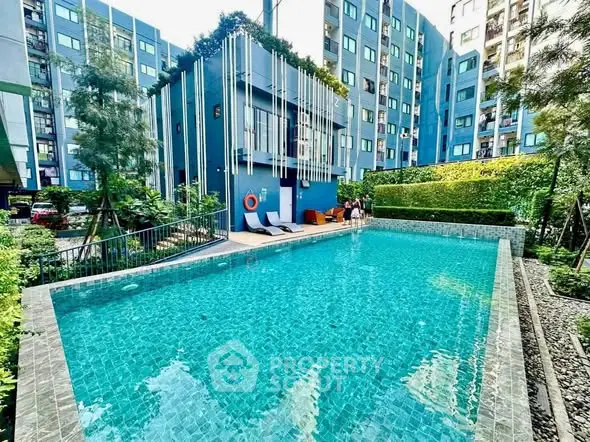 Luxurious apartment complex with a sparkling outdoor pool and lush greenery, perfect for relaxation and leisure.
