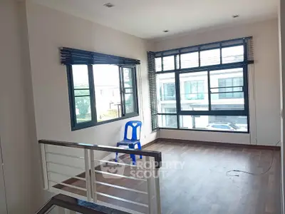 Spacious room with large windows and wooden flooring, perfect for natural light lovers.