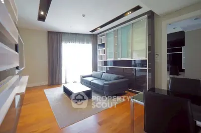 Spacious modern living room with sleek furniture and large window for natural light.