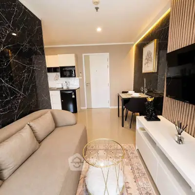 Modern living room with elegant decor and open layout, featuring a cozy sofa and stylish dining area.