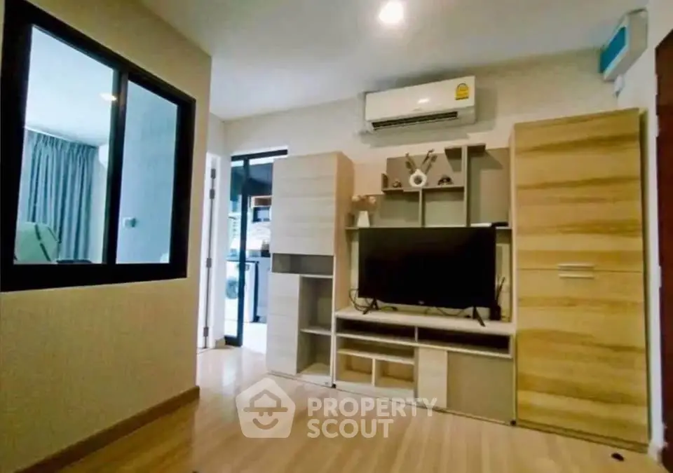 Modern living room with stylish wooden furniture and air conditioning, perfect for cozy living.