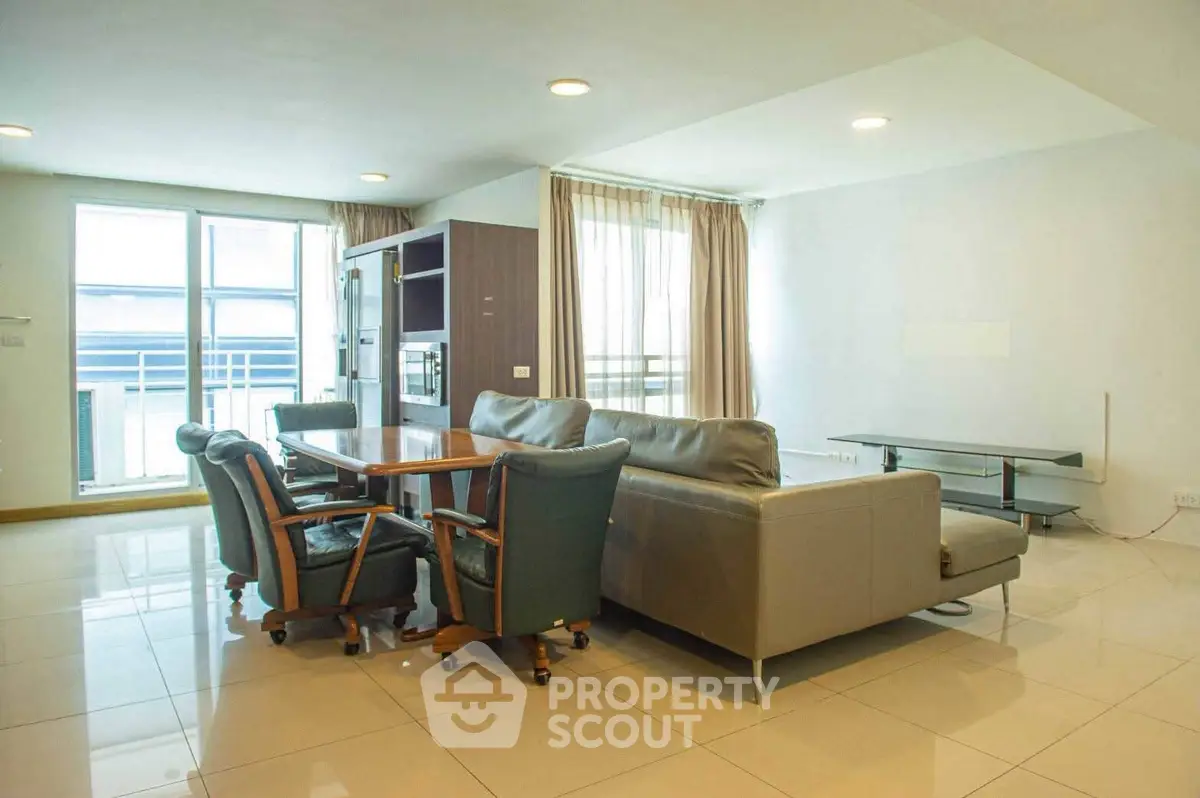 Spacious living room with modern furniture and large windows for natural light.