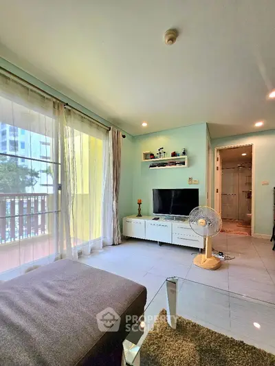 Bright living room with modern decor and balcony view in urban apartment