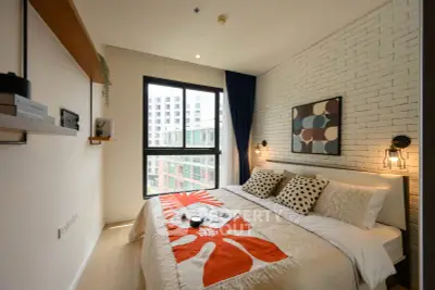 Modern bedroom with stylish decor and large window offering city view