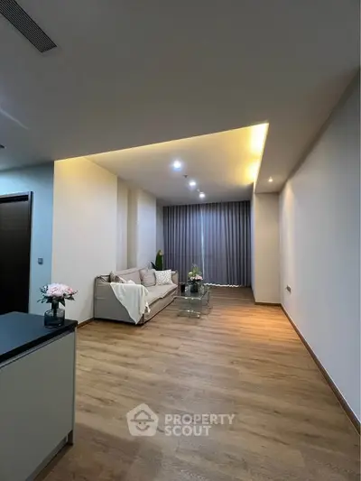 Spacious modern living room with elegant lighting and wooden flooring