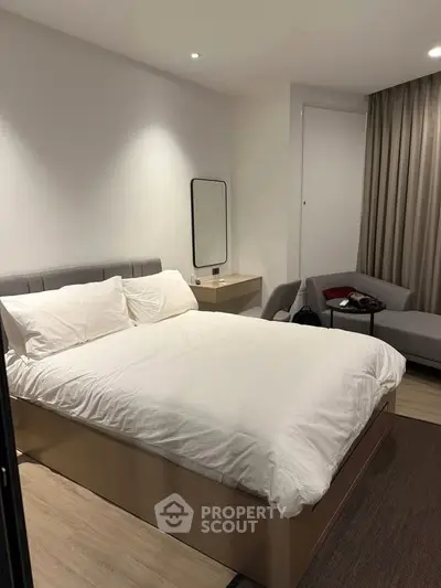 Modern bedroom with cozy bed, stylish furniture, and elegant decor in a contemporary apartment.