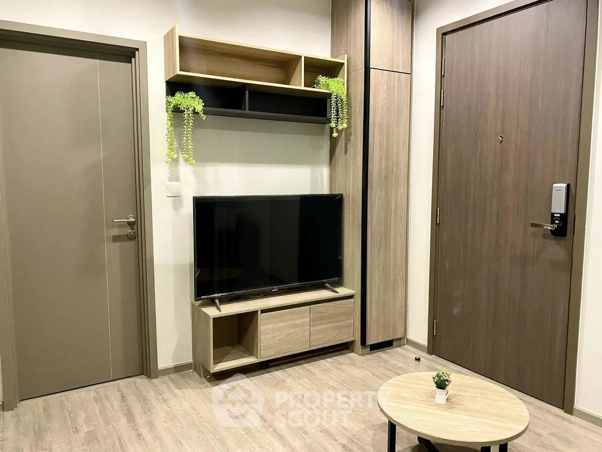 Modern living room with sleek TV stand and stylish decor in a contemporary apartment.
