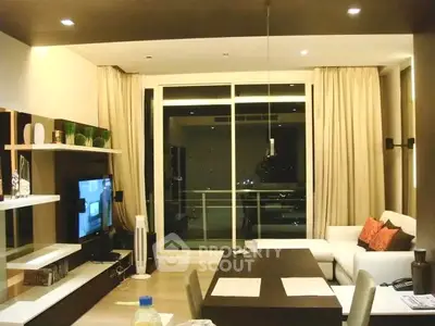 Modern living room with large windows and stylish decor in a high-rise apartment.