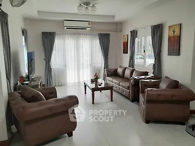 Spacious living room with elegant leather sofas and natural light