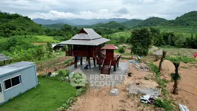 Charming elevated wooden house with scenic mountain views and lush greenery, perfect for nature lovers.