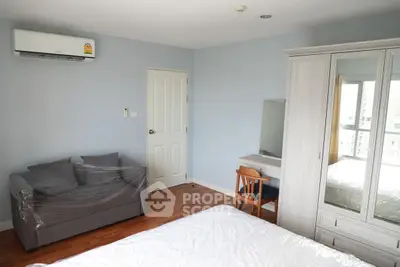 Spacious bedroom with modern furniture and natural light