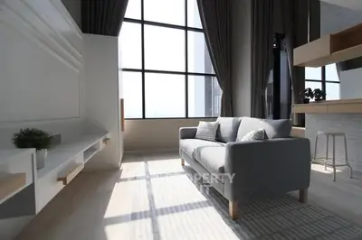 Modern living room with large windows and stylish furniture