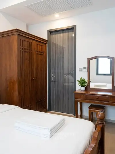 Charming bedroom with wooden furniture and modern decor, perfect for a cozy retreat.
