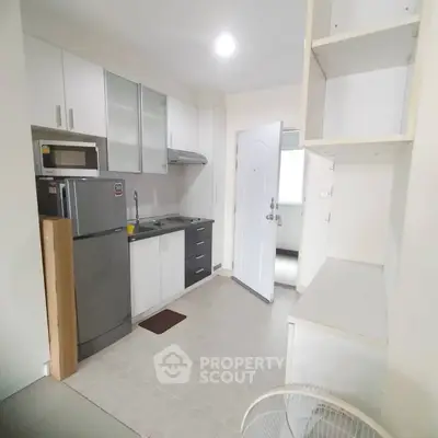 Modern kitchen with sleek appliances and ample storage in a bright, compact space.