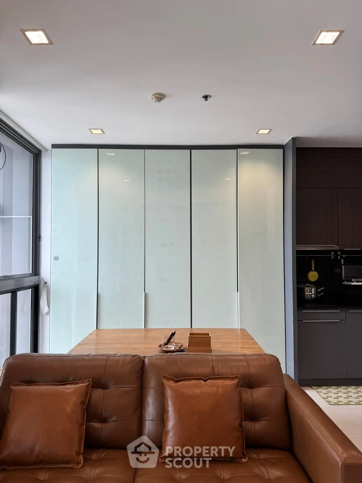 Modern living room with sleek design and brown leather sofa