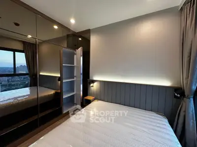 Modern bedroom with built-in mirrored wardrobe and city view