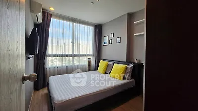 Modern bedroom with large window and stylish decor in urban apartment