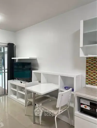 Modern living room with sleek white furniture and built-in storage