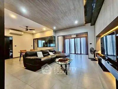 Spacious modern living room with sleek design and large windows for natural light.