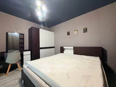 Modern bedroom with stylish furniture and cozy lighting, perfect for relaxation and comfort.