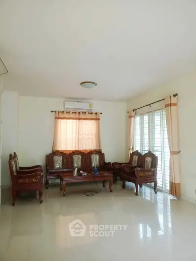 Spacious living room with elegant wooden furniture and natural light