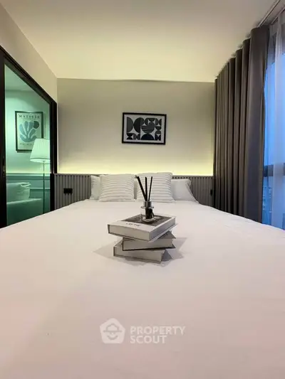 Modern bedroom with stylish decor and cozy ambiance, featuring elegant lighting and contemporary artwork.