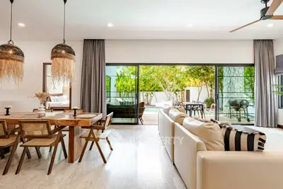 Luxurious open-plan living room with pool view and stylish decor