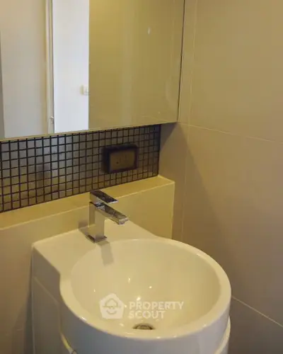 Modern bathroom with sleek sink and stylish tile backsplash