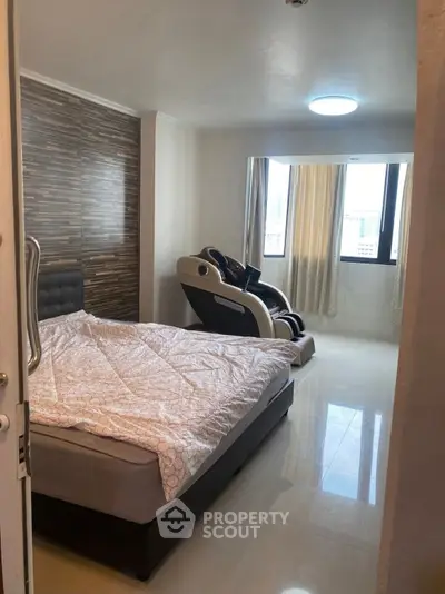 Modern bedroom with massage chair and large window view