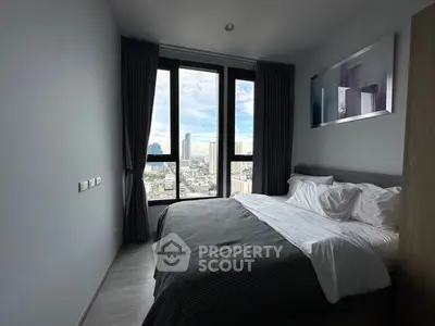 Modern bedroom with large window offering stunning city view, featuring cozy bed and elegant decor.