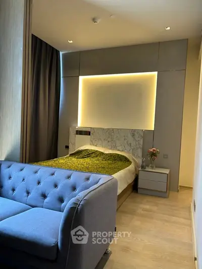 Modern bedroom with stylish lighting and cozy sofa in a chic apartment