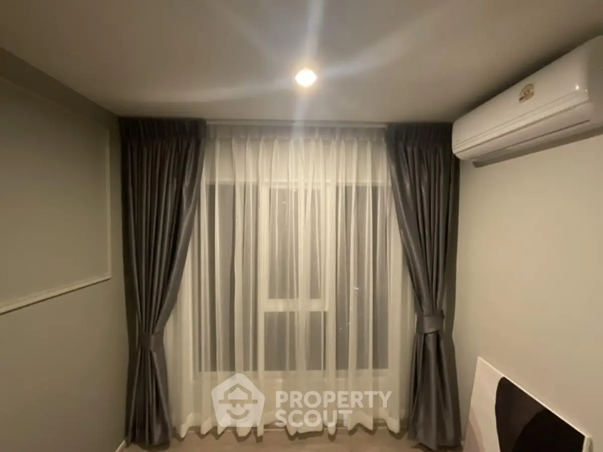 Cozy bedroom with elegant curtains and air conditioning