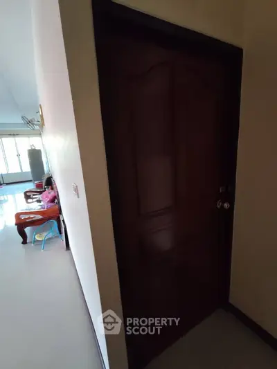 Spacious interior with wooden door and bright living area, ideal for family living.