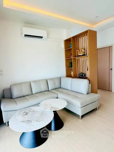 Modern living room with stylish sectional sofa and elegant coffee tables