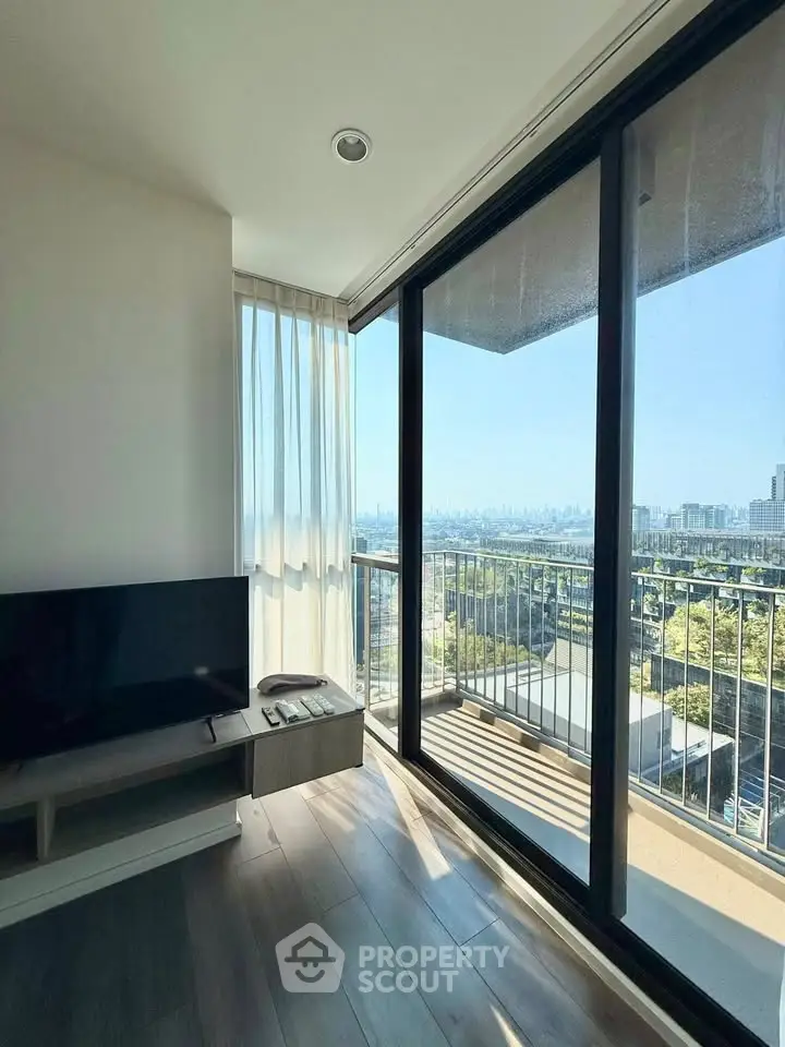 Modern living room with stunning city view and large balcony access.