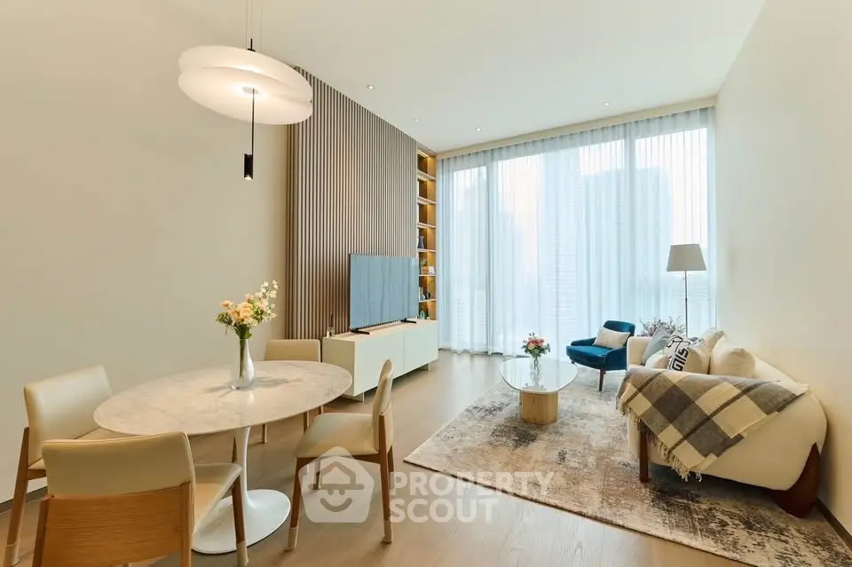 Elegant modern living room with high ceilings, large windows, and stylish furniture, perfect for urban living.