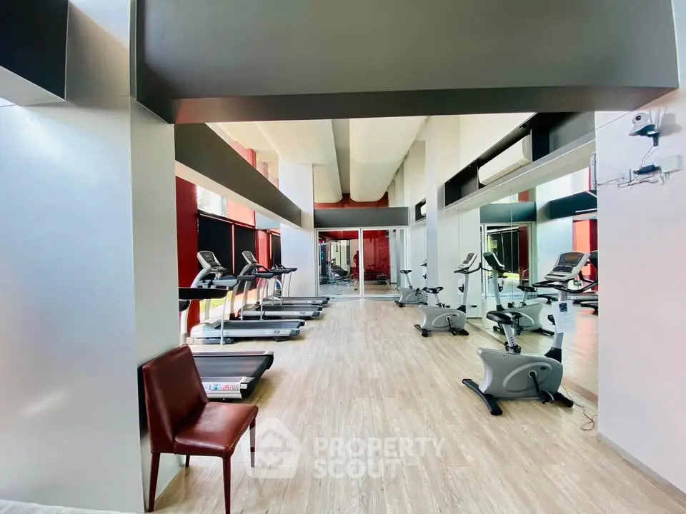 Spacious modern gym with state-of-the-art equipment and sleek design
