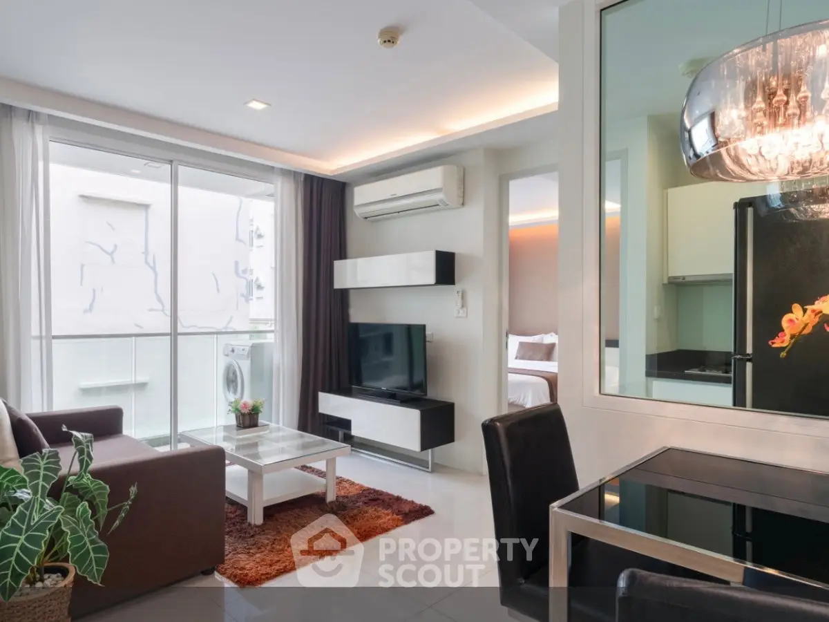 Modern living room with sleek furniture and large windows in a stylish apartment.
