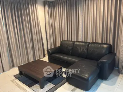 Elegant living room with black leather sofa and modern coffee table