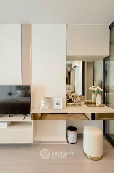 Modern living room with elegant decor and sleek furniture, featuring a stylish TV unit and decorative accents.